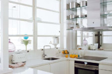 07 The kitchen is all-white, it’s modern and laconic, and a mirror wall make it look bigger