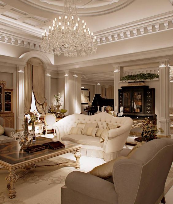 a refined living room with an oversized crystal chandelier with a lot of bulbs