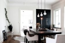07 a simple black wooden table is accentuated with cool bulbs and white upholstered chairs