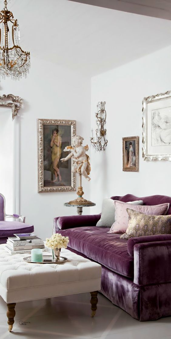 antique-style purple couch with an upholstered base and a matching chair