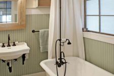 07 vintage-inspired bathroom with a clawfoot tub and black accents to pull everything off