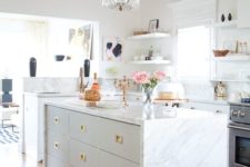 08 a modern glam kitchen with a tall hanging chandlier with brass details and sheer crystals