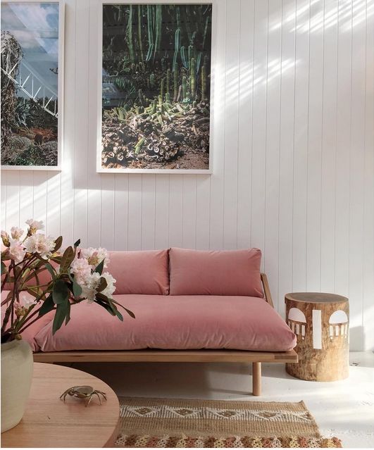 modern pink sofa on a light wooden base with legs