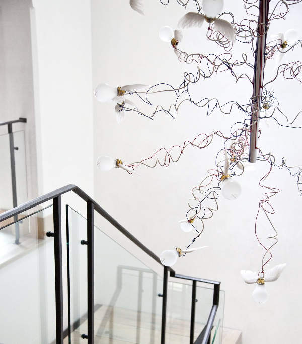 The stairs are marked with a snitch-inspired chandelier, which looks crazy and cute