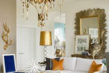 09 a whimsy living room with a chic brass chandelier and gold hanging details