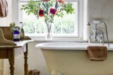 09 rustic bathroom with an ivory bathtub with white legs on a wooden stand