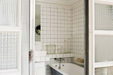 10 The bathroom features subway tiles, a free-standing blue bathtub