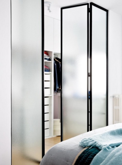 The closet is separated with foldable frosted glass doors that save the space