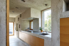 10 The kitchen is also made of concrete completely, and is clad with oak wood