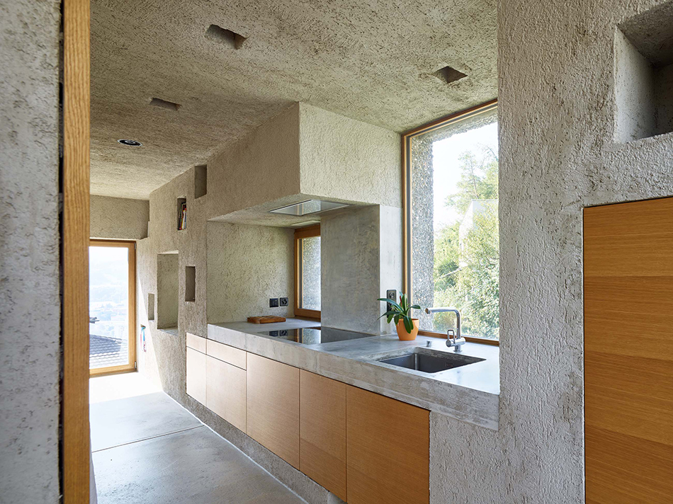 The kitchen is also made of concrete completely, and is clad with oak wood