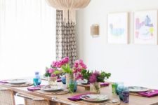 10 a modern boho dining space with wicker furniture and a large glam chandelier