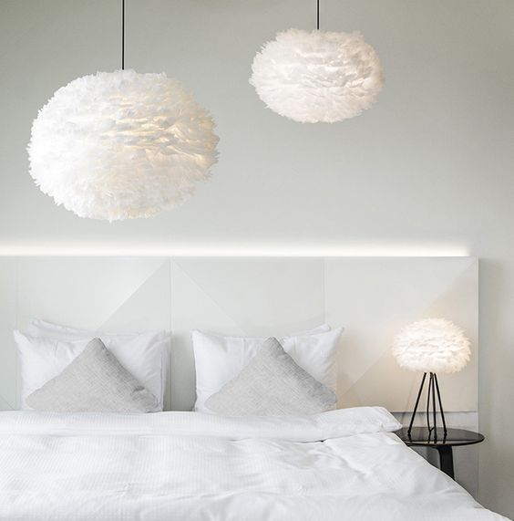large feather pendant lamps and an echoing table one create an airy feeling