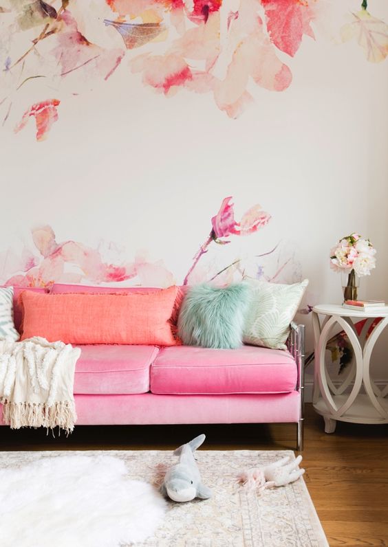 pink sofa with peachy pillows and nickel legs