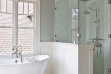 10 vintage-inspired bathroom in neutral colors with a white clawfoot bathtub on silver legs