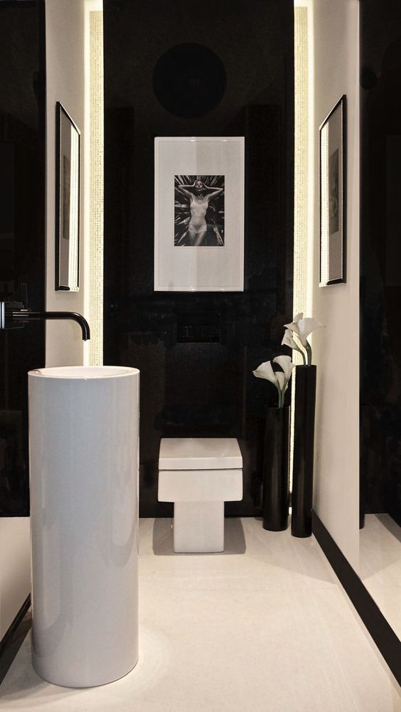 white free-standing sink in a black and white bathroom
