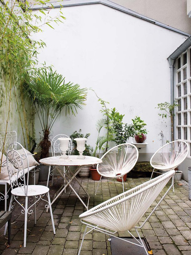 There's also a terrace with mid-century modern furniture and greenery