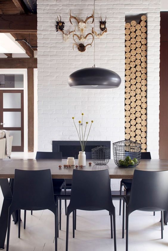 a simple wooden table is highlighted with chic modern chairs in black color and an echoing lamp