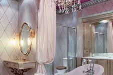 11 a vintage feminine bathroom with a pink ceiling and a lawfoot tub, a vintage crystal chandelier