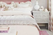11 bed with a pink upholstered headboard for a glam feel