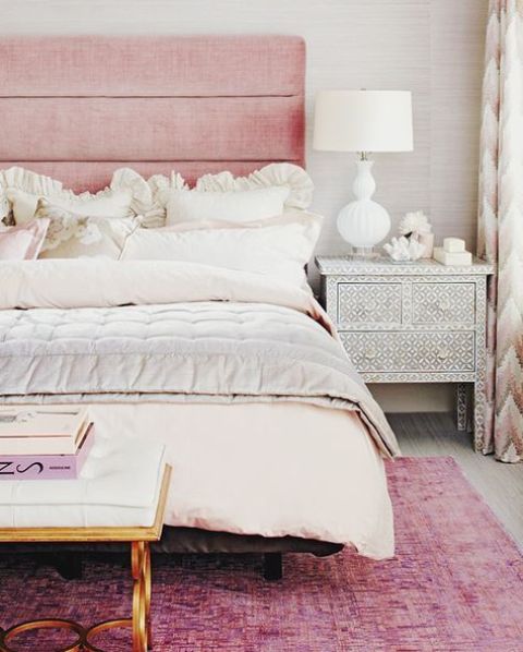 bed with a pink upholstered headboard for a glam feel