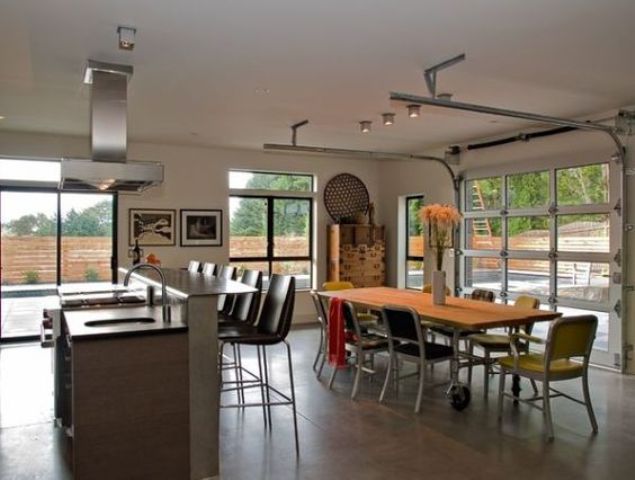open plan kitchen and dining space with sectioned glass garage doors