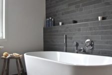 11 peaceful grey tile bathroom with a large freestanding bathtub