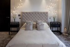 12 modern glass pendant lamp combos on each side of the bed bring a wow factor