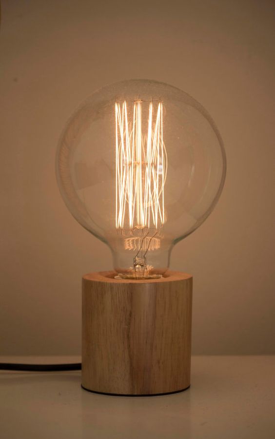 modern table lamp made of a wooden base and a large bulb looks very natural