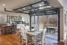 12 the dining space is opened to the deck with the help of garage doors
