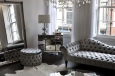 13 a silver grey living room with a large crystal chandelier with candle-inspired bulbs