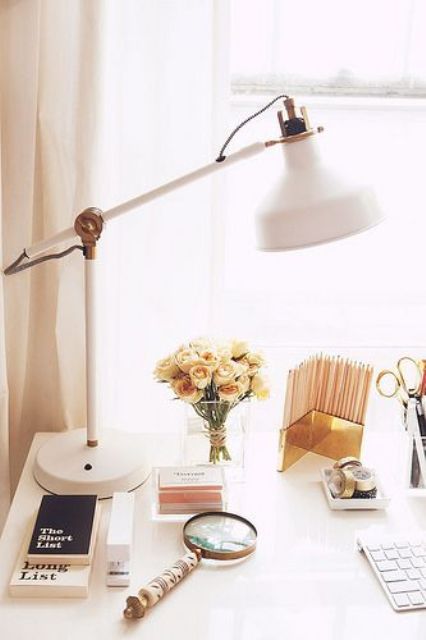 a white modern lamp with brass elements for a glam home office