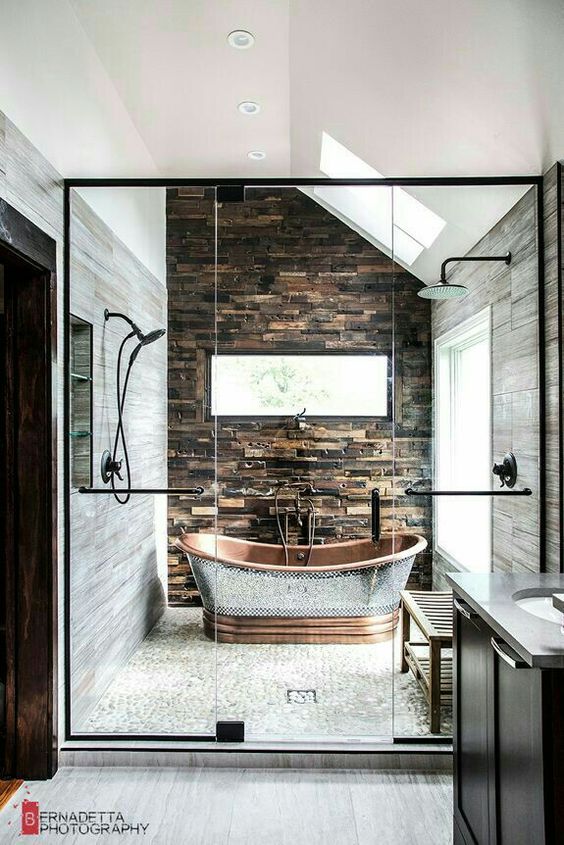 stone, tiles and a metal bathtub in the shower area as a showstopper