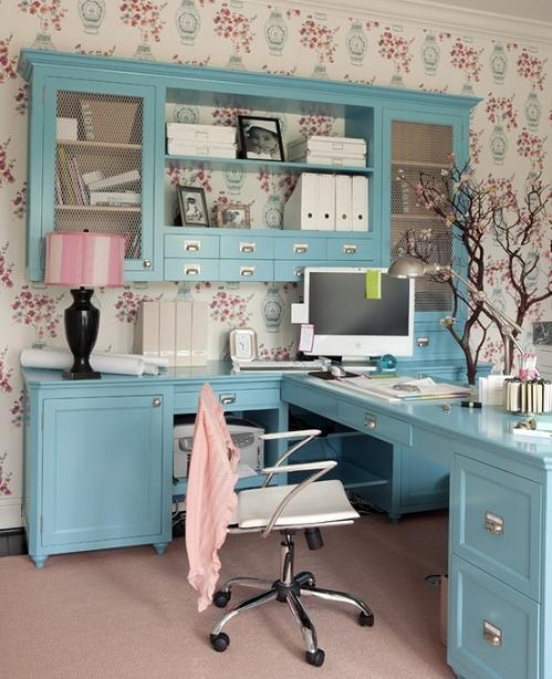 blue cabinets and a desk create a united system and look very cute