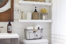 14 floating shelves for a farmhouse style bathroom and wicker baskets for storage