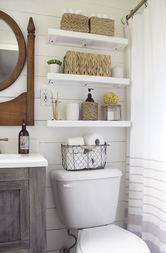 floating shelves for a farmhouse style bathroom and wicker baskets for storage