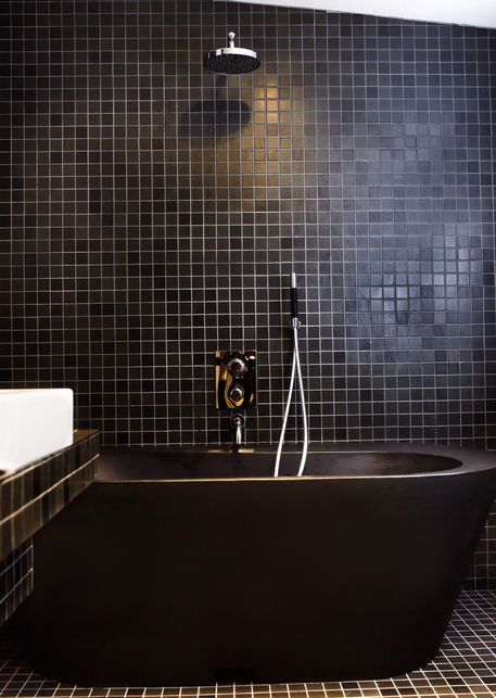 a dark matte bathtub is perfect for any modern masculine bathroom
