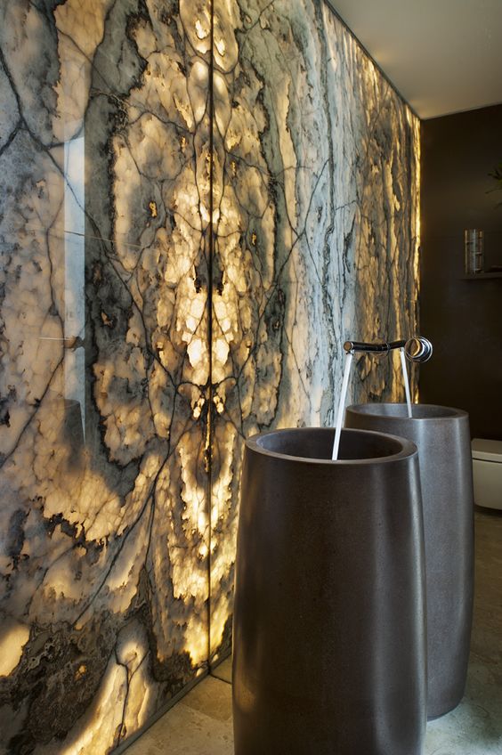 black stone sinks inspired by cigars in front of a backlit wall