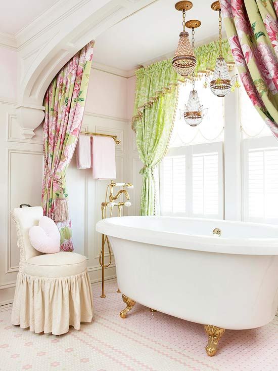 a girlish space with a white tub on gilded legs looks cute
