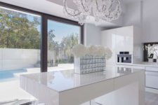 17 a minimalist white kitchen is spruced up with a modern crystal covered chandelier