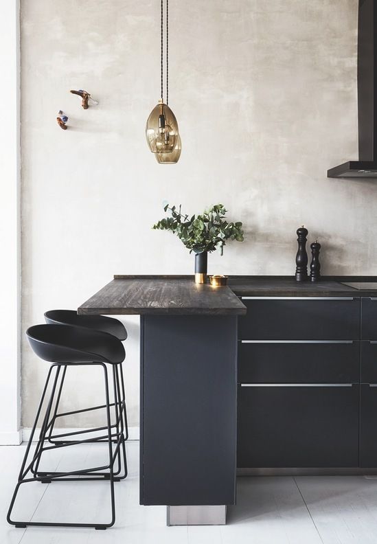 elegant black kitchen island with a wooden counter, small modern stools