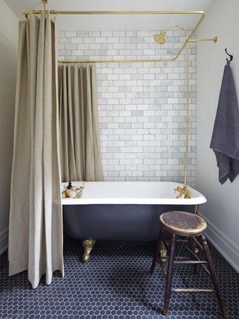 Retro inspired bathroom with a black clawfoot tub on metallic legs looks very elegant