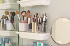 17 small floating shelves next to the bathroom mirror for storing all your makeup