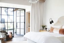 18 a modern bedroom with layered rugs and a chic crystal round chandelier of bubbles