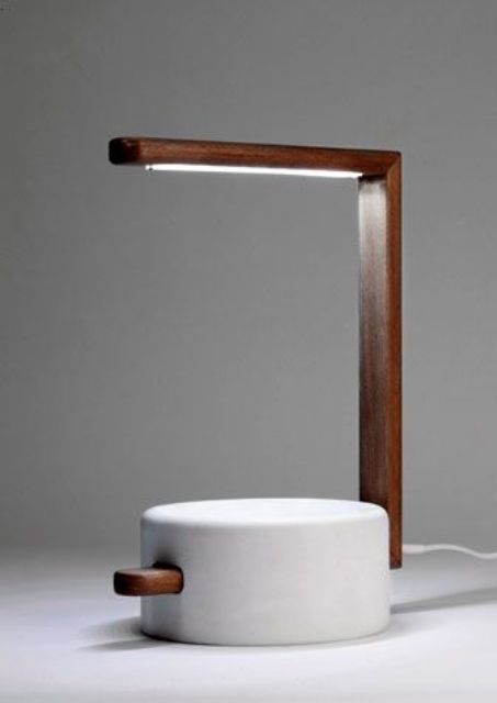 a table lamp in wood and a composite of marble powder and resin
