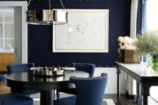 18 navy velvet chairs with nailhead trim echo with a navy wall