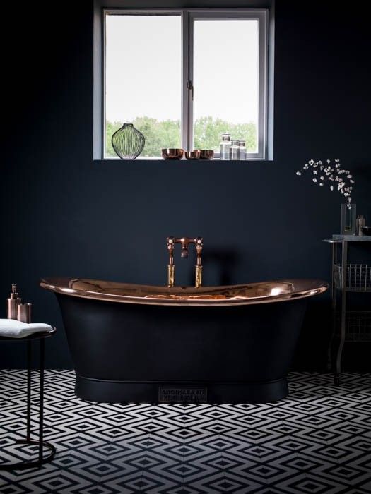 charcoal bathtub with a copper finish inside for an art deco space
