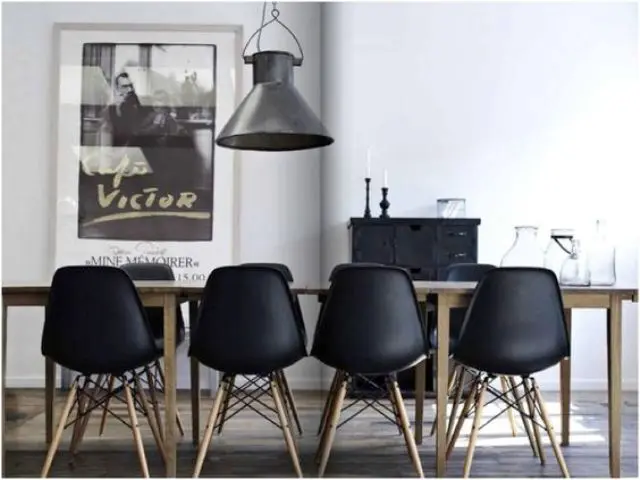 Modern black chairs accentuate a light colored wooden table