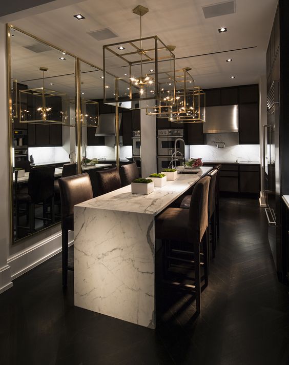 a marble waterfall kitchen island with upholstered chairs