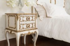 20 a white bedside table with gilded accents for an exquisite bedroom