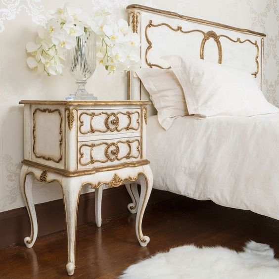 a white bedside table with gilded accents for an exquisite bedroom